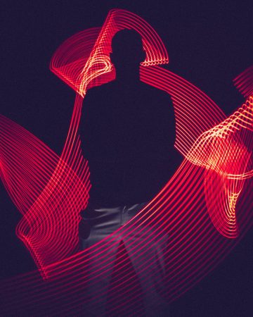 Man silhouette surrounded by red graphical waves